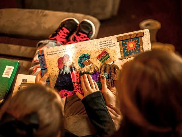 Children sharing a picture book